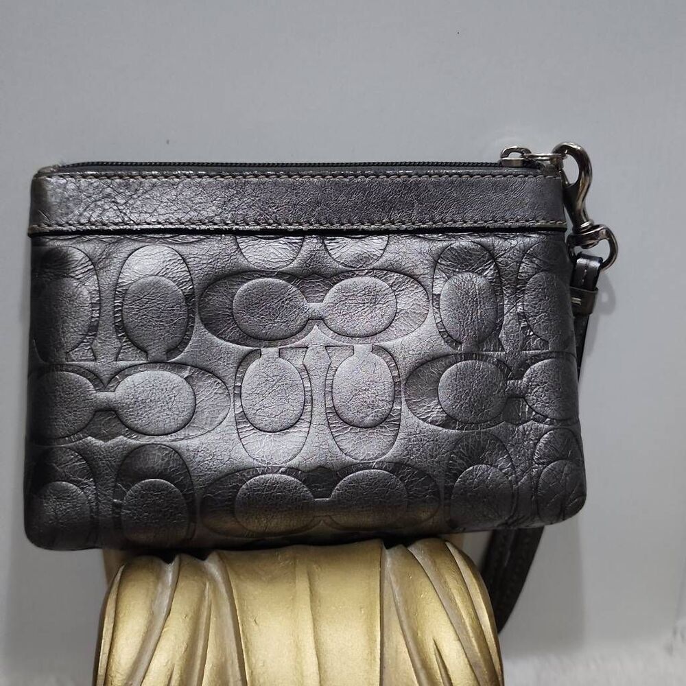 Coach signature embossed metallic Grey leather wristlet.